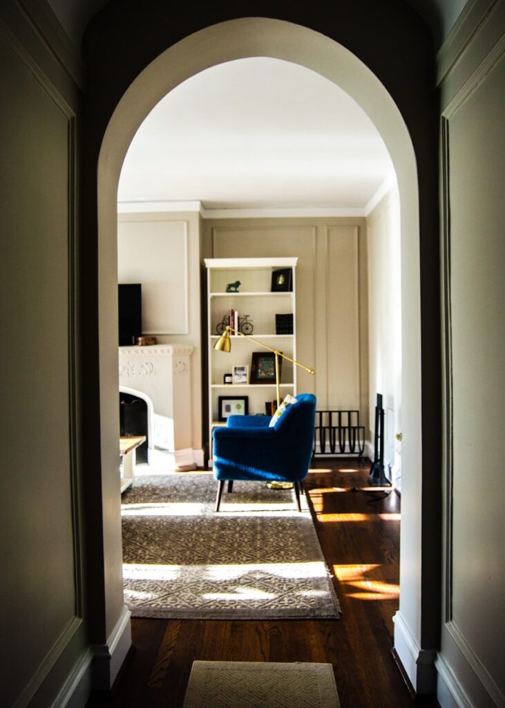 blue fabric sofa on gray area mat inside room